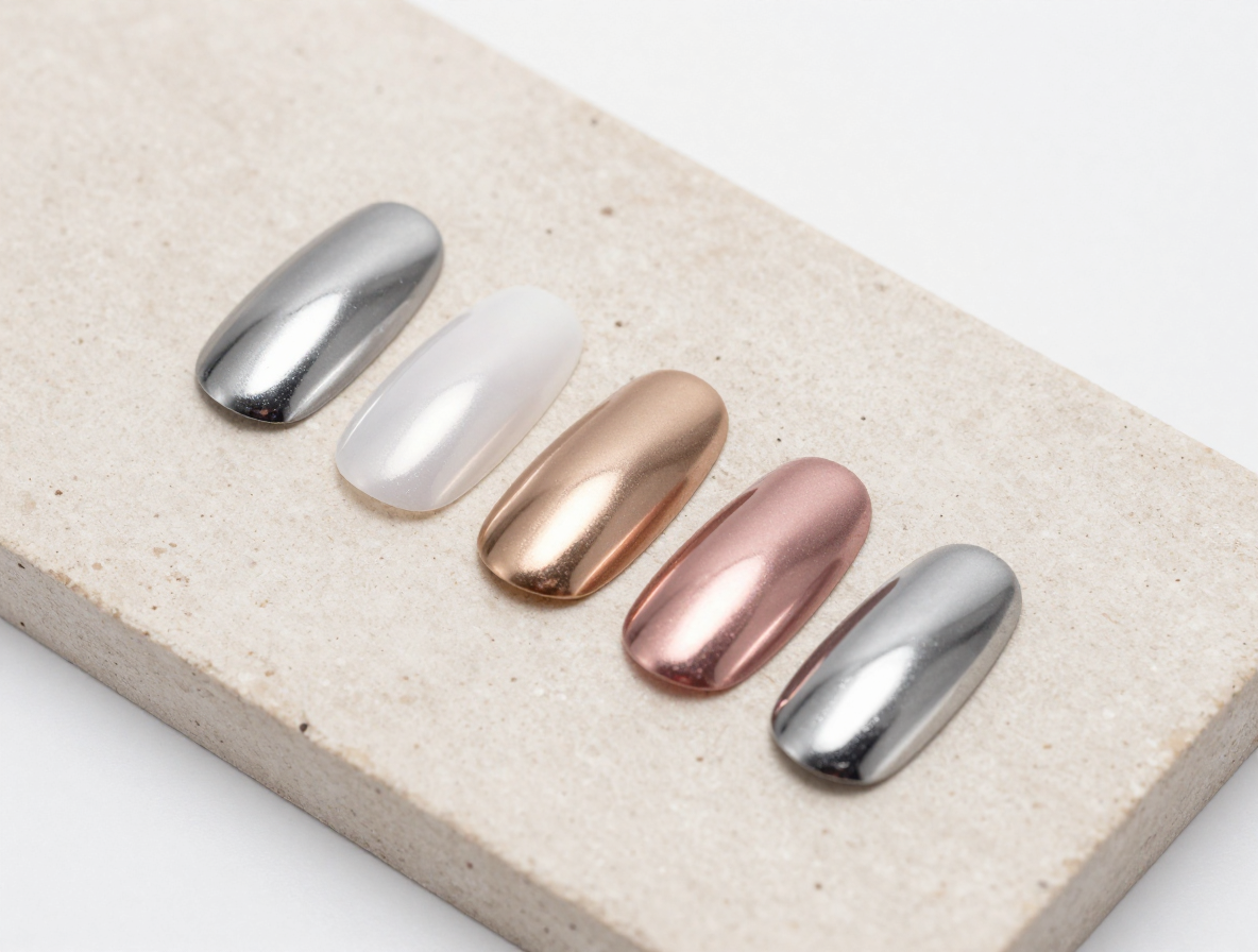 A salon-style display comparing mirror silver, glazed pearl, champagne, rose, and gunmetal chrome manicure finishes.